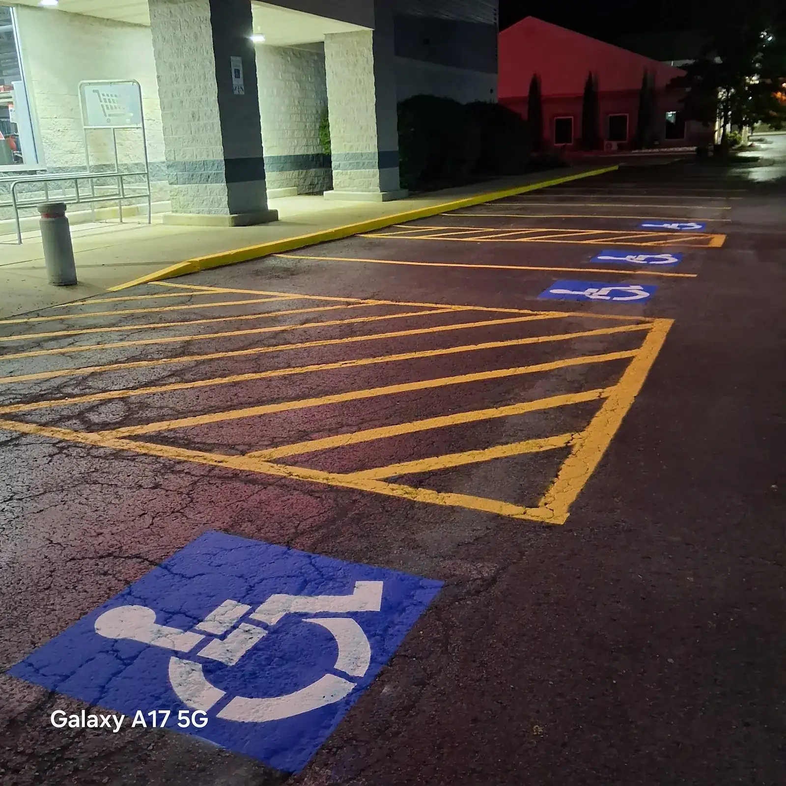 A bright ADA parking marking on a freshly striped lot