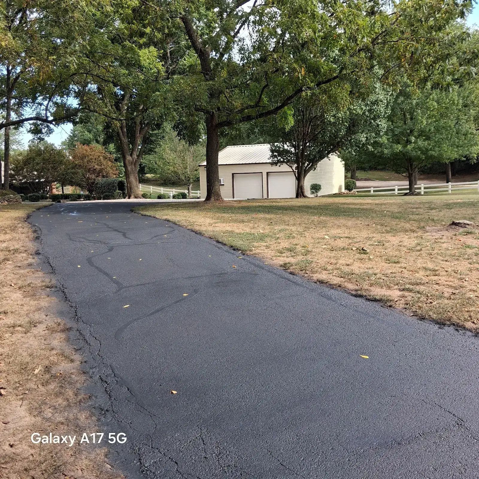 A freshly sealed blacktop driveway