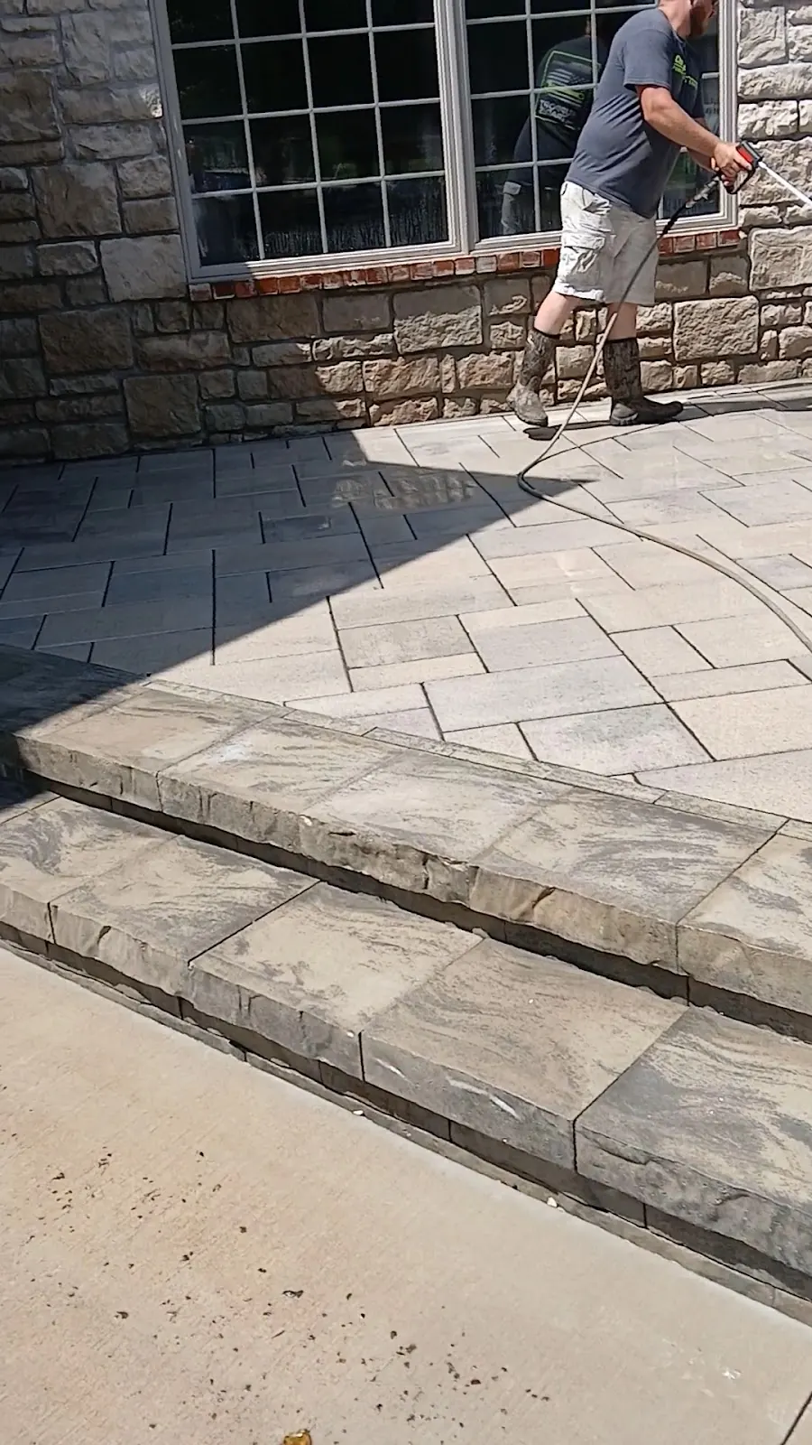 A Reliable Pro technician pressure washing stone steps